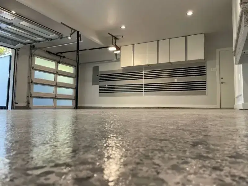 A garage with a concrete floor and a garage door.