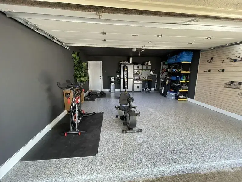 A garage with a bicycle and a bench in it.